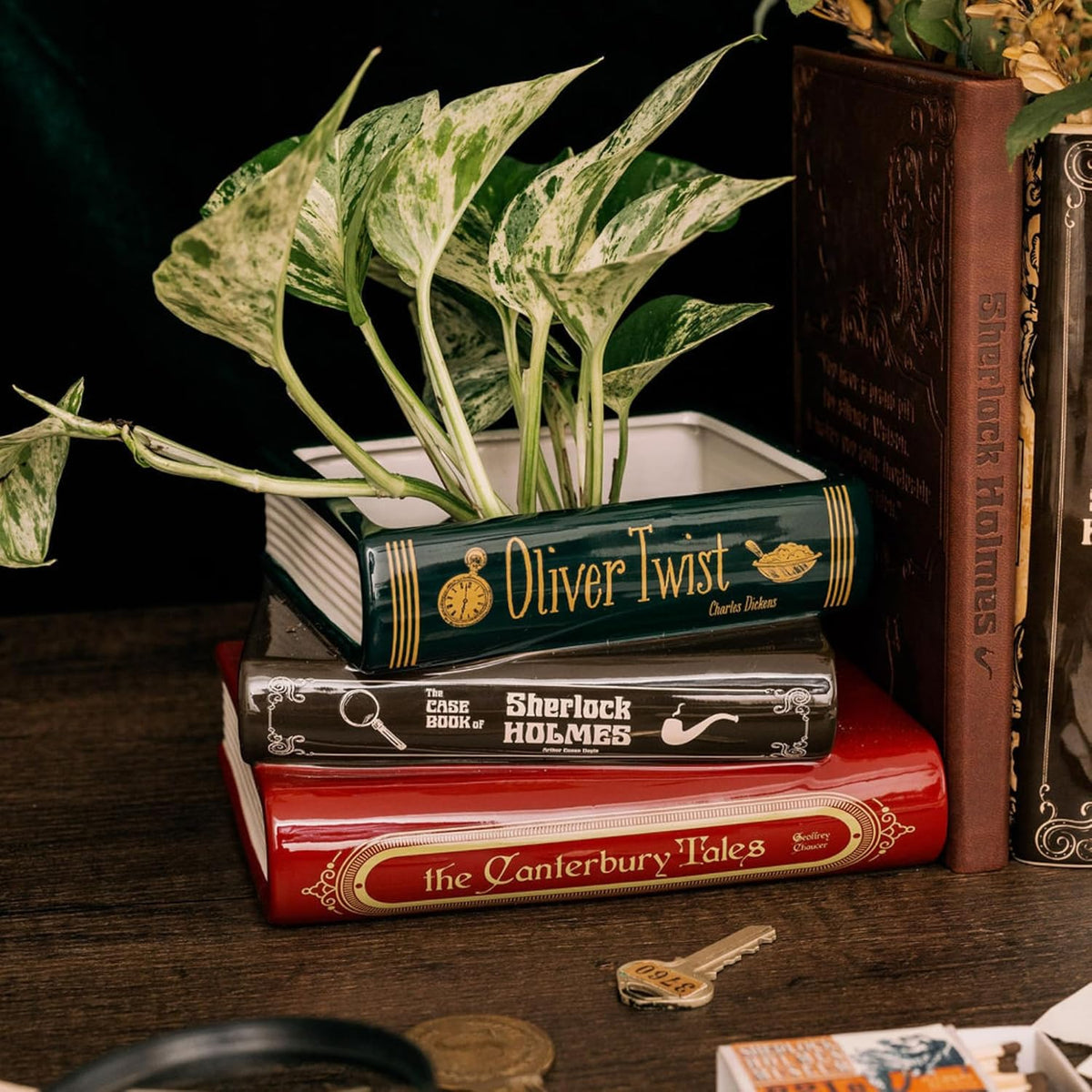 Steel Mill & Co stacked book planter styled with a trailing houseplant and literary decor